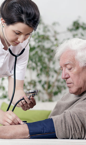 Nurse Checking Elderly Man's Blood Pressure